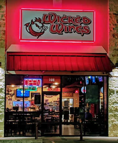 Wicked Wings storefront at night